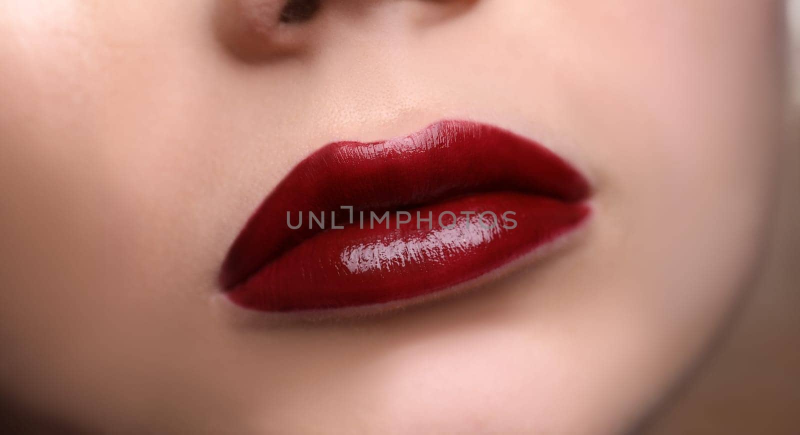 Closeup of beautiful female lips with red lipstick by kuprevich