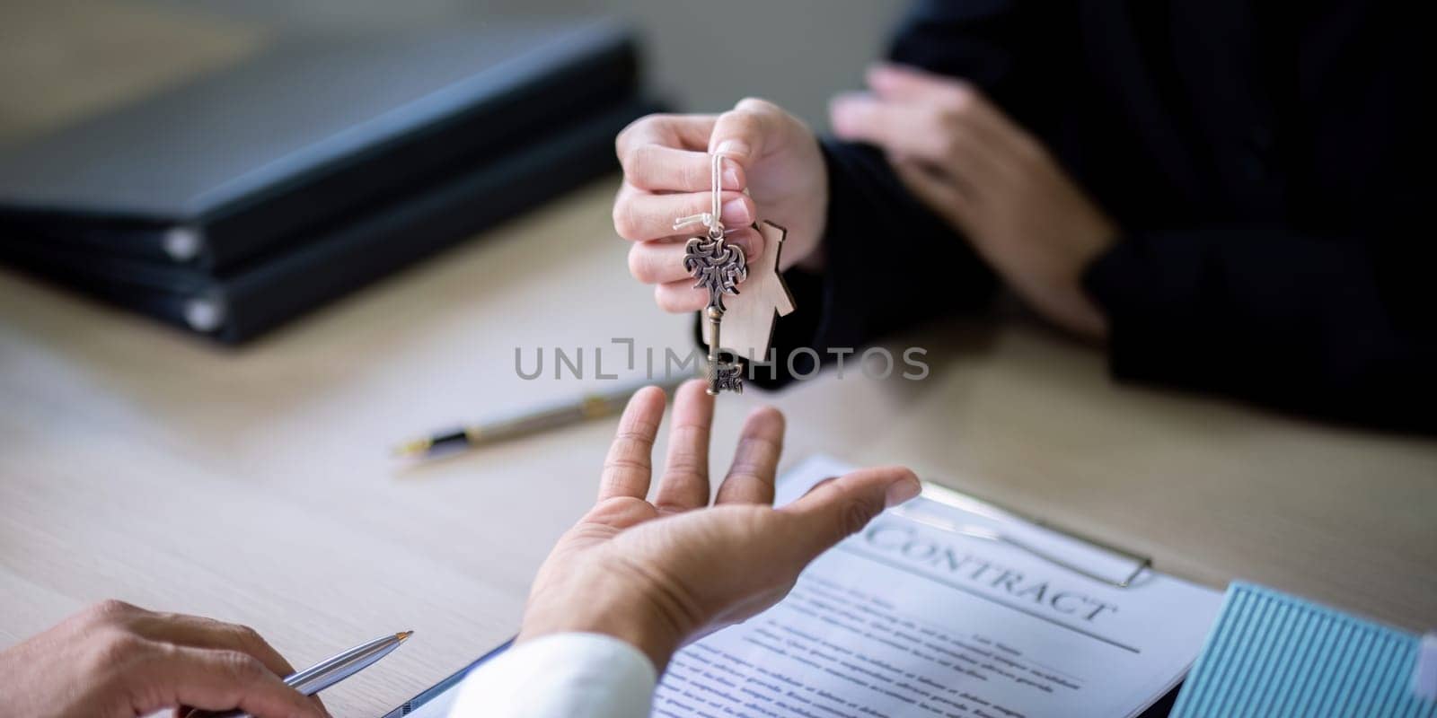Real estate agent agree to buy a home and give key to client at agency office. Concept agreement.