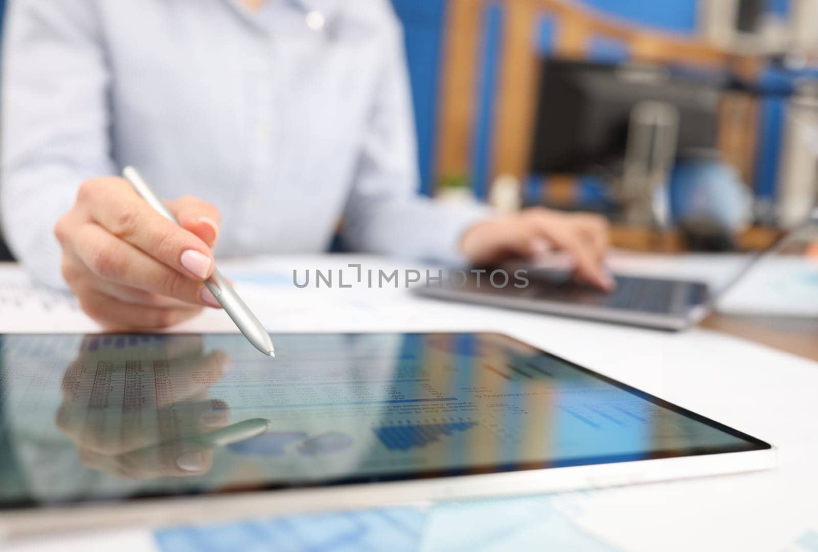 Female hand studying information on digital tablet with stylus closeup by kuprevich