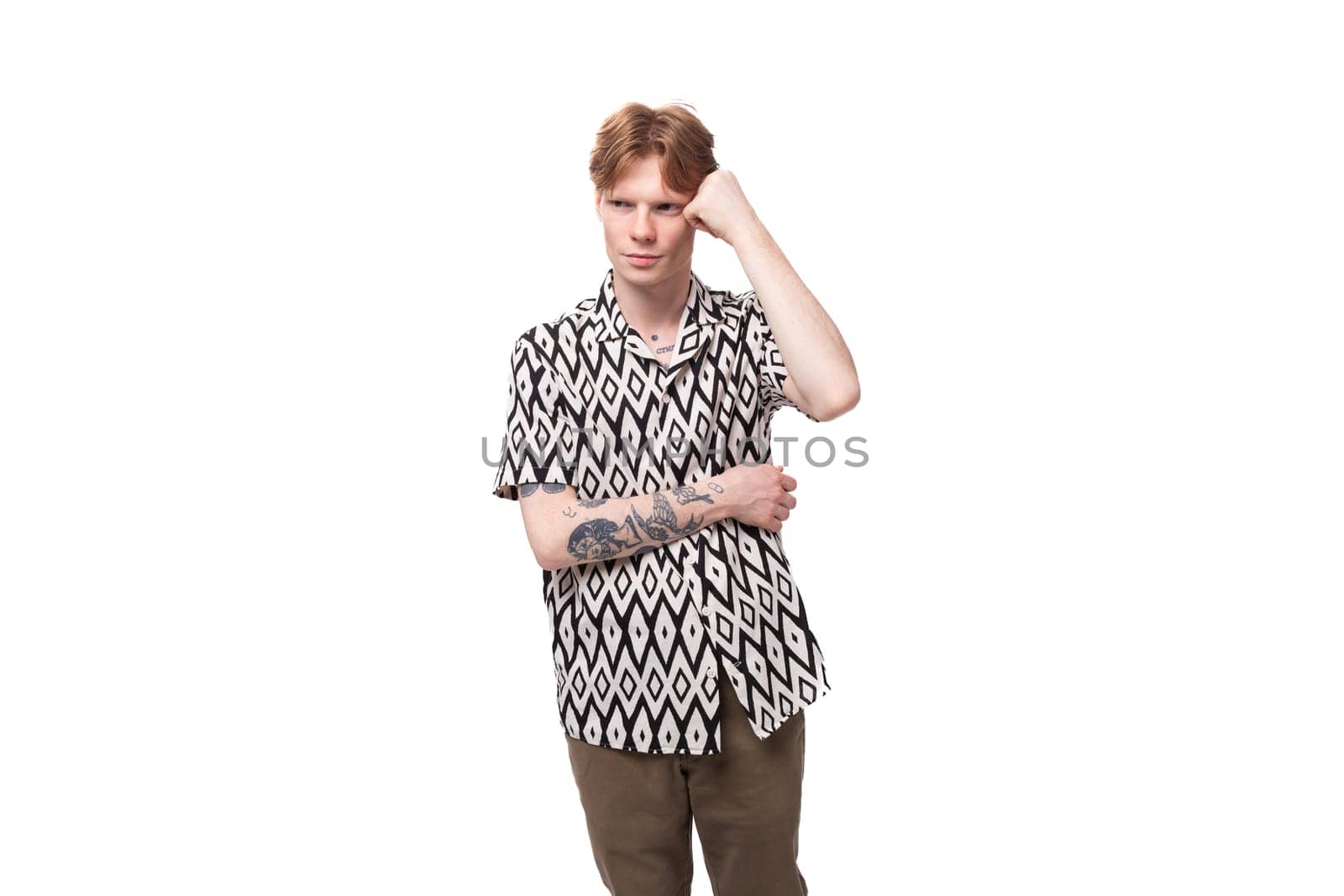 a young indignant guy with red hair and a tattoo on his arms is dressed in a short-sleeved shirt experiencing negative emotions by TRMK
