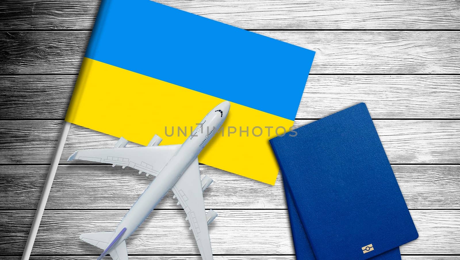 Ukrainian flag and toy plane on gray background. High quality photo