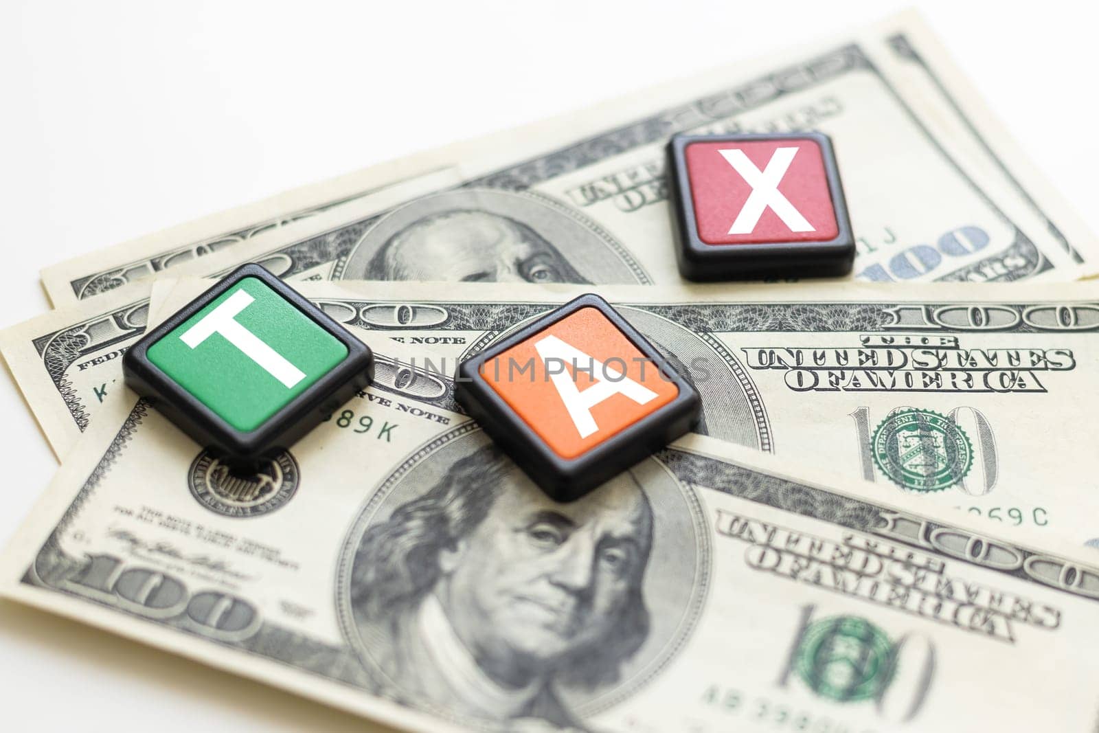 word TAX on wooden cubes, grey background, business concept. High quality photo