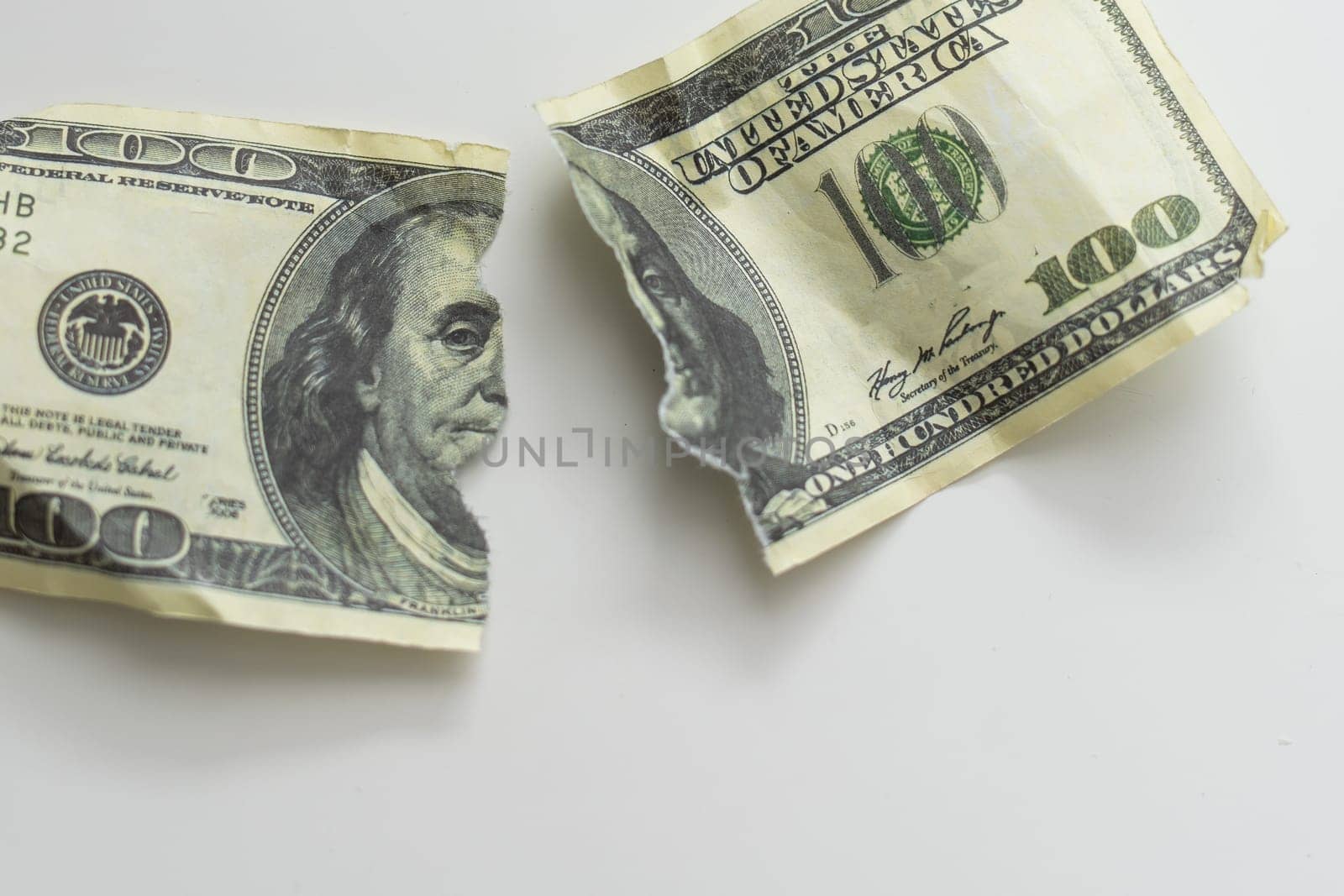 Ripped Money One Hundred Dollar Bill Isolated on White Background. High quality photo