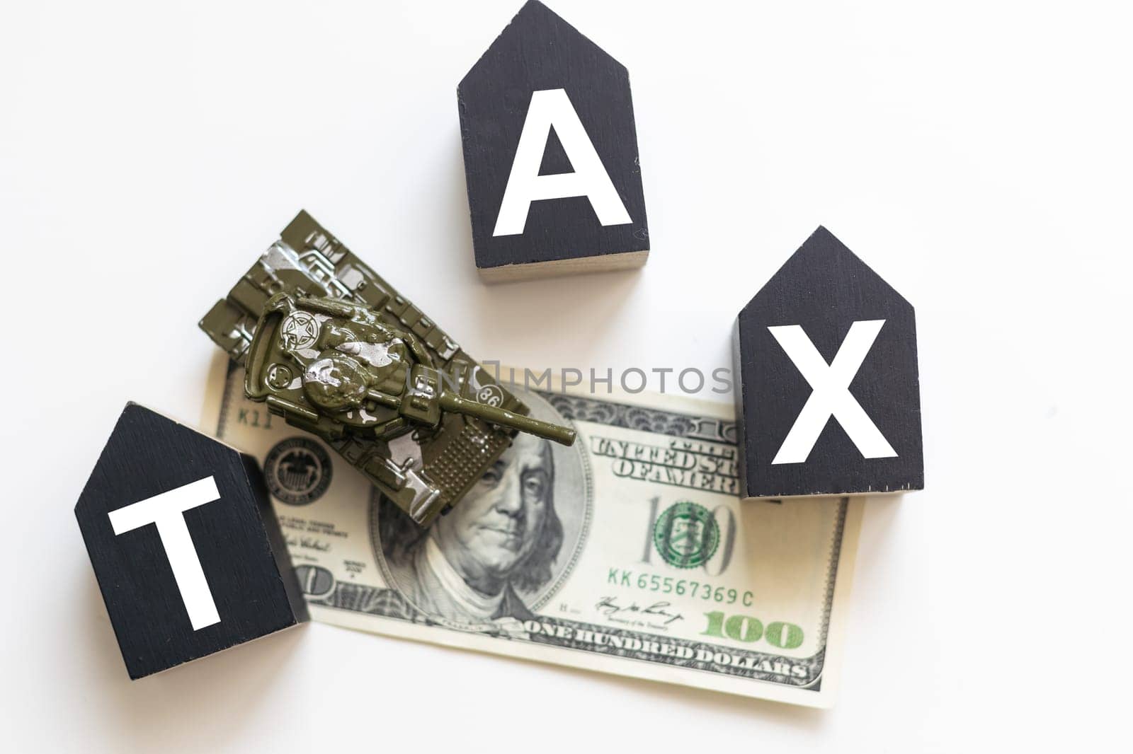 Tax text in wooden cubes and tax or vat form documents to complete Individual income tax return form for payment to Government. Calculation tax return in 2022 to 2023. High quality photo