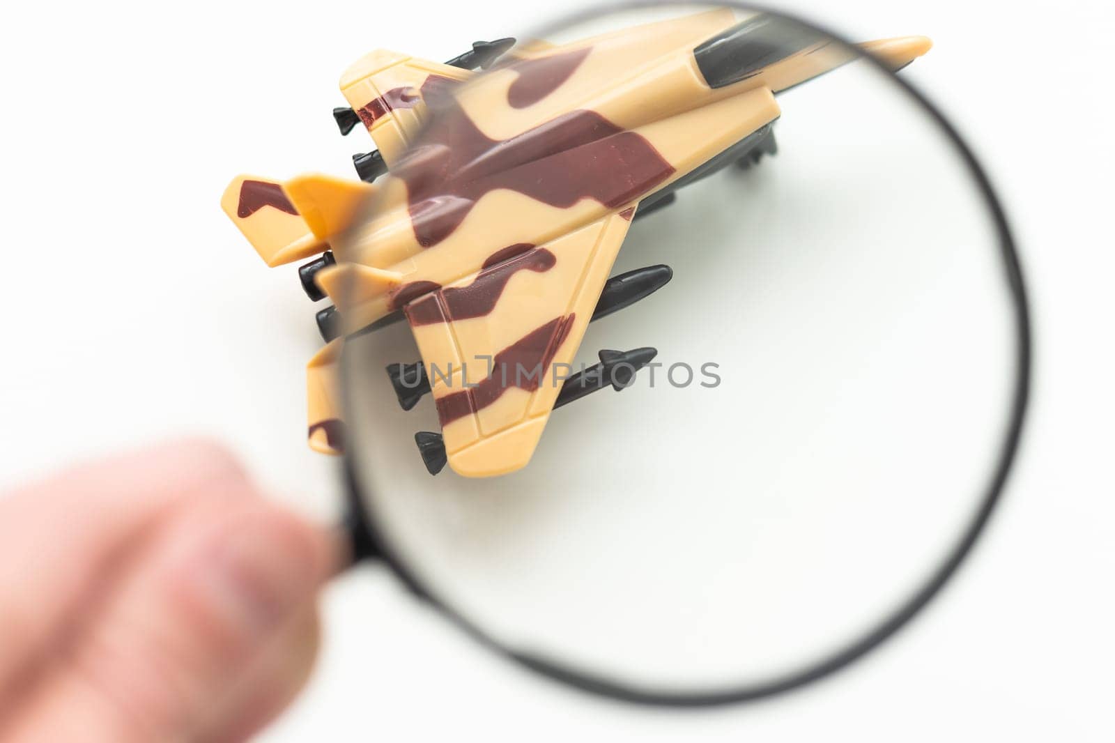 Review airlines company service and tickets price concept. Airplane model under magnifying glass on grey background. by Andelov13