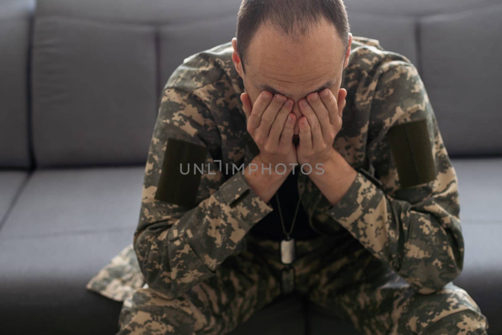 PTSD concept military man sits on a black background soldier suffers. High quality photo