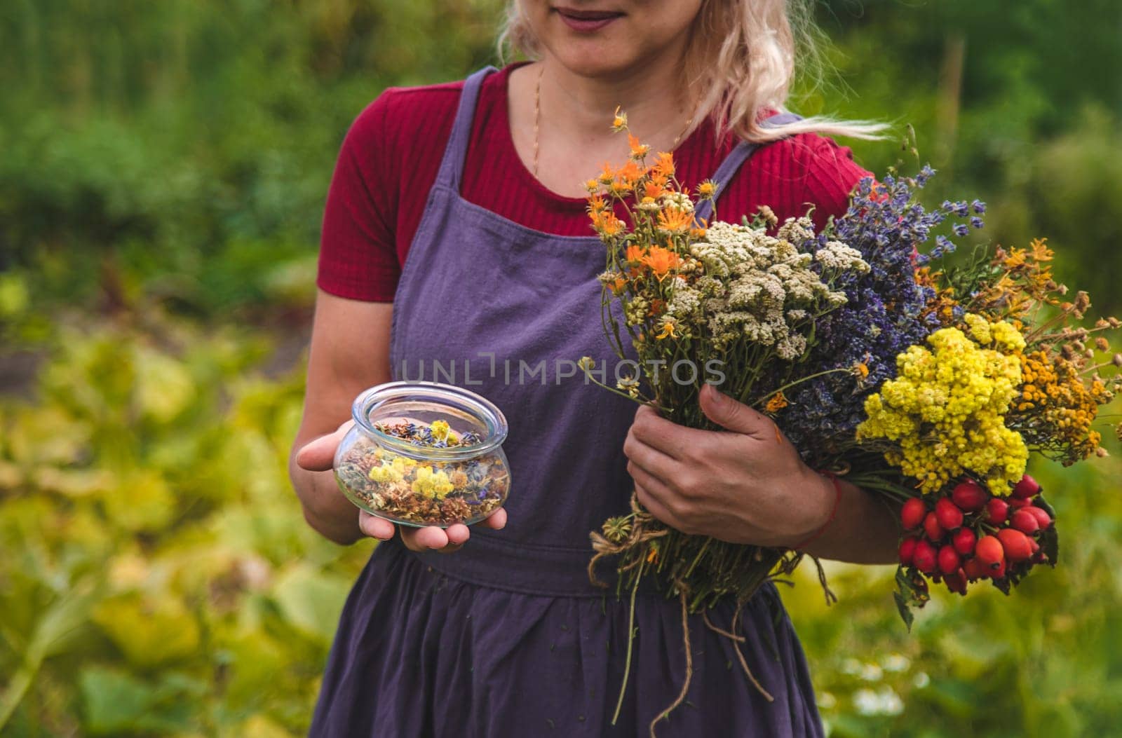A woman holds an herbal extract in her hands. Selective focus. by yanadjana
