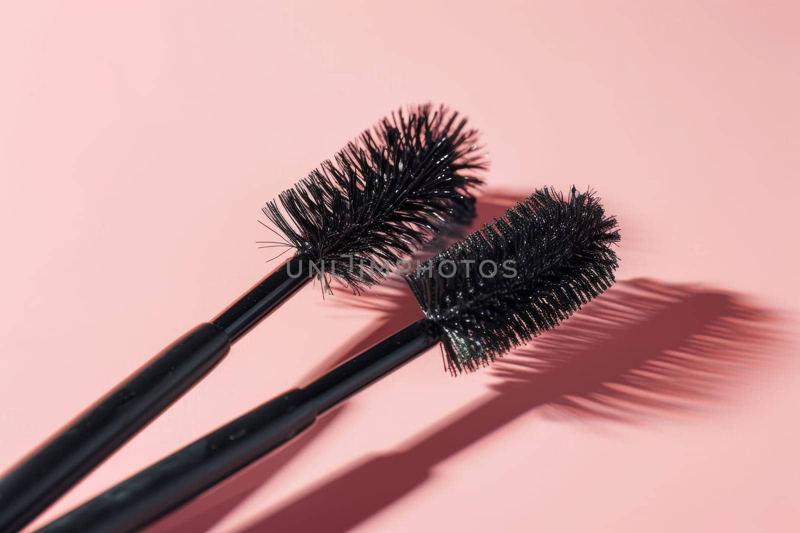 Black eyelash brushes on a pink background. Women's cosmetics. Face Makeup.