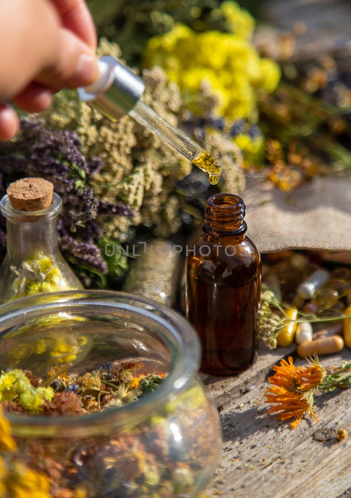 Dried herbs medicinal tinctures extracts in the garden. Selective focus. by yanadjana