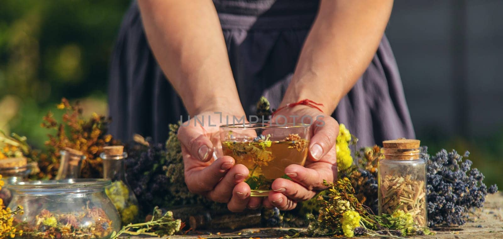 A woman brews herbal tea. Selective focus. by yanadjana