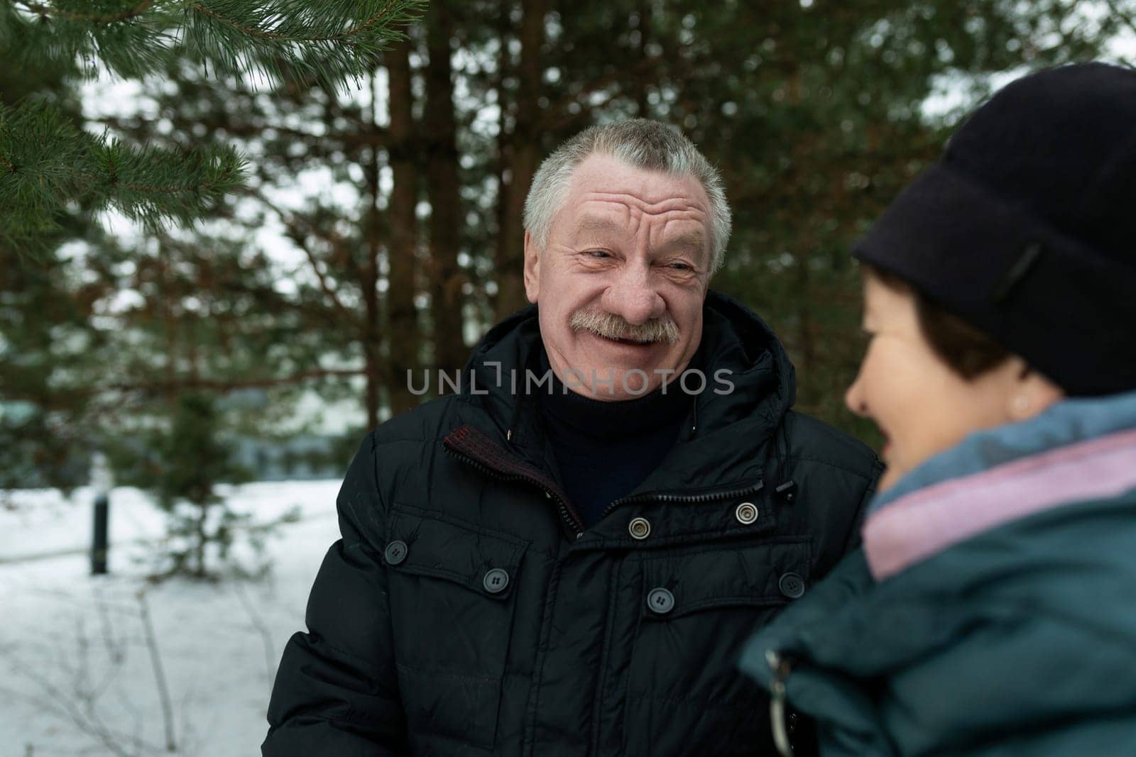 Mature husband and wife love each other and walk even in cold weather.