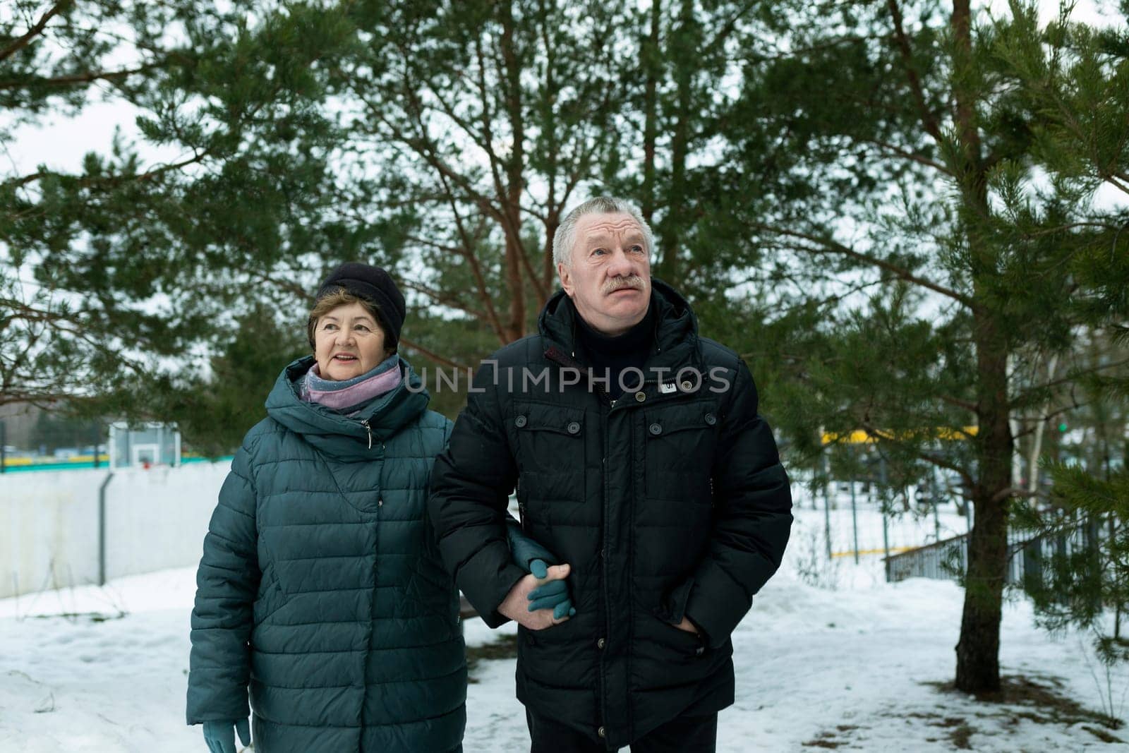 Cute mature couple went for a walk in the cold season of winter by TRMK