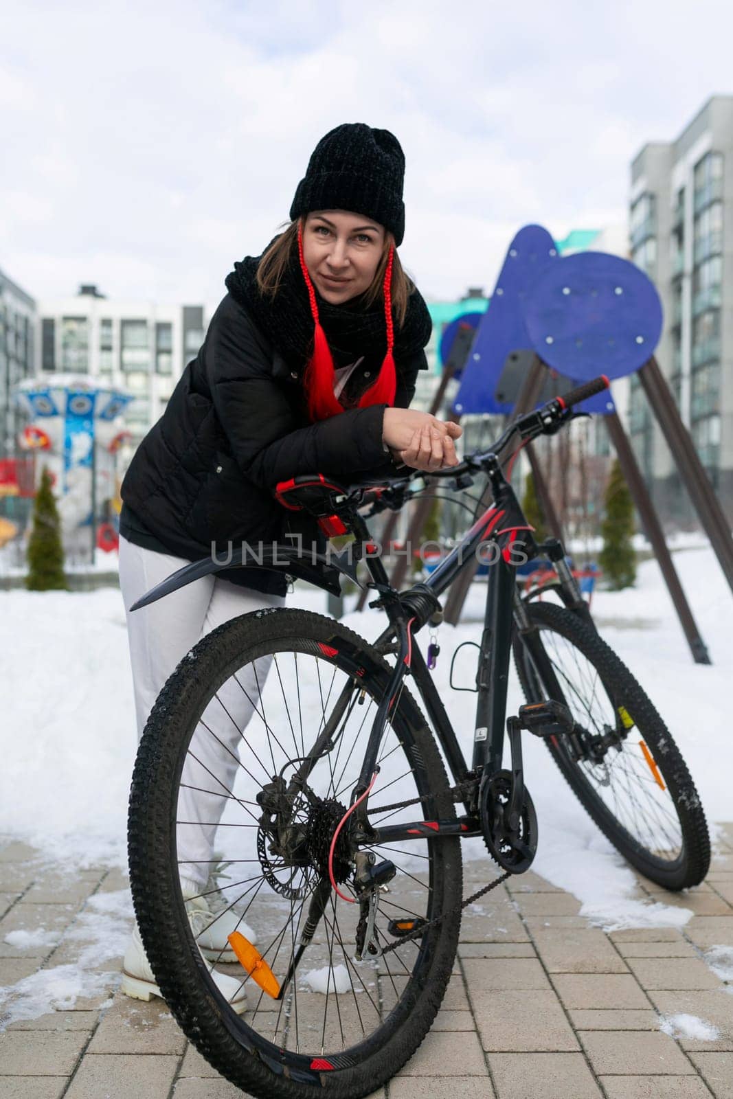 A woman rented a bicycle to ride around the city in winter. by TRMK