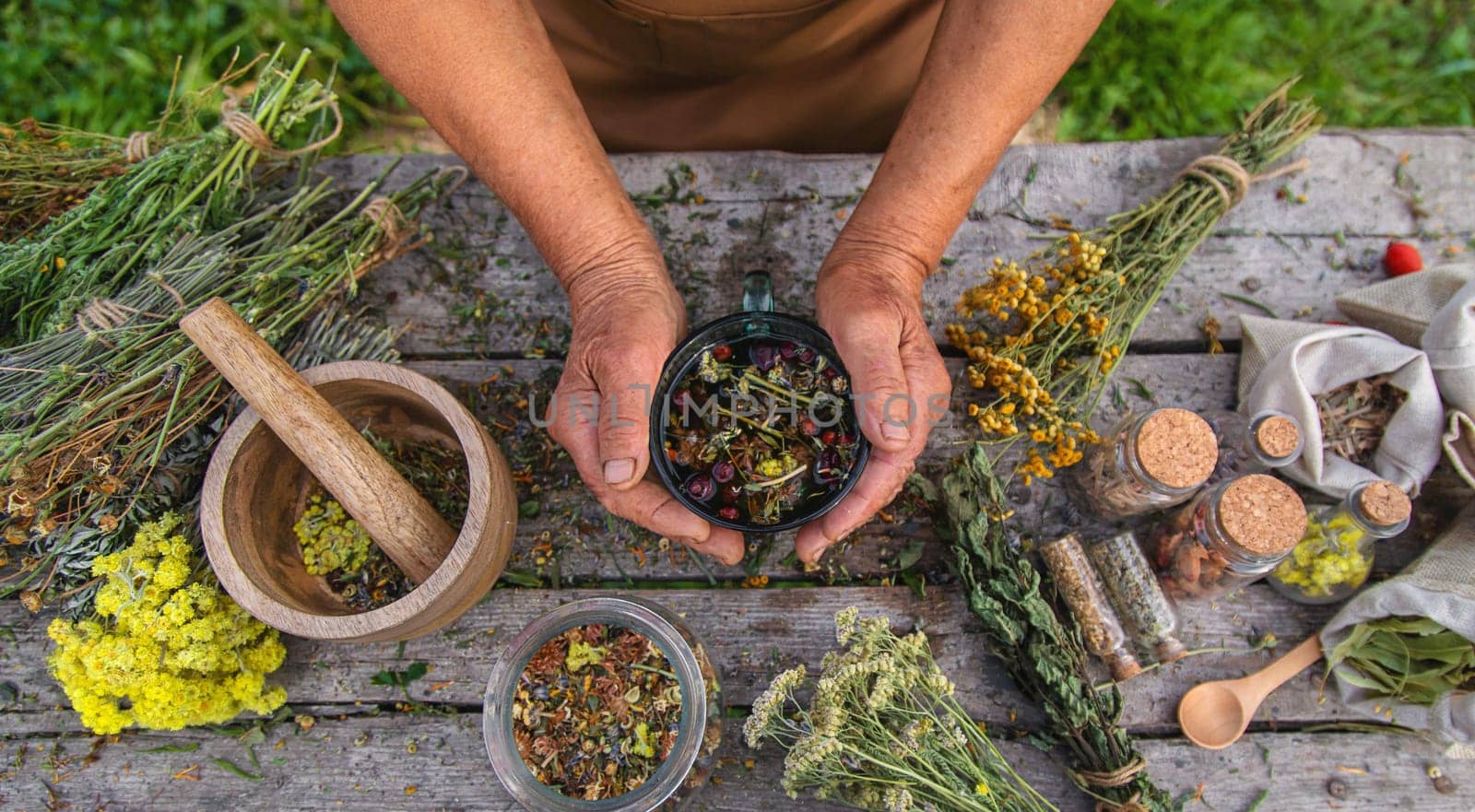 An elderly woman brews herbal tea. Selective focus. by yanadjana