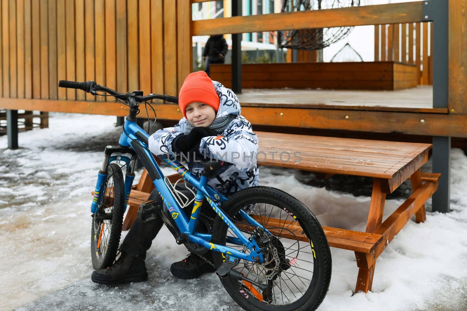 Boy riding a bike during winter holidays.