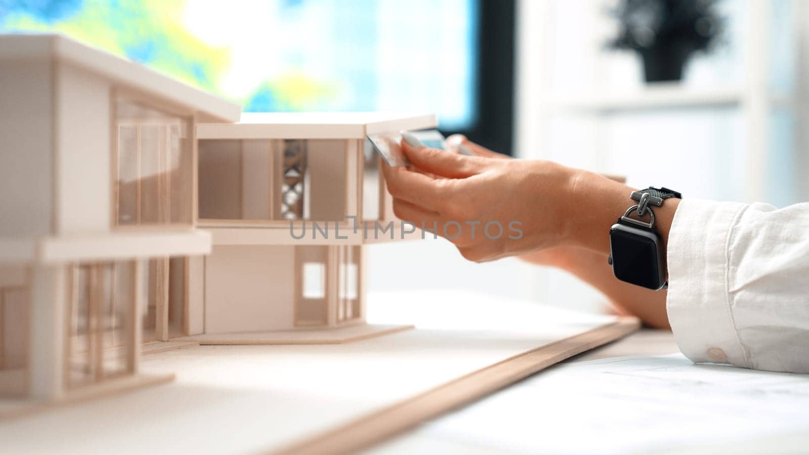 Young beautiful architect hand measure house model by using ruler. Immaculate. by biancoblue