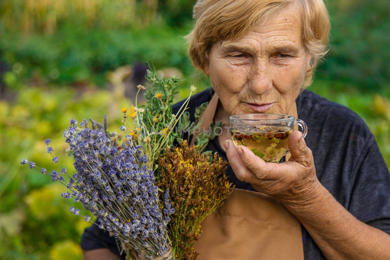 An elderly woman brews herbal tea. Selective focus. by yanadjana