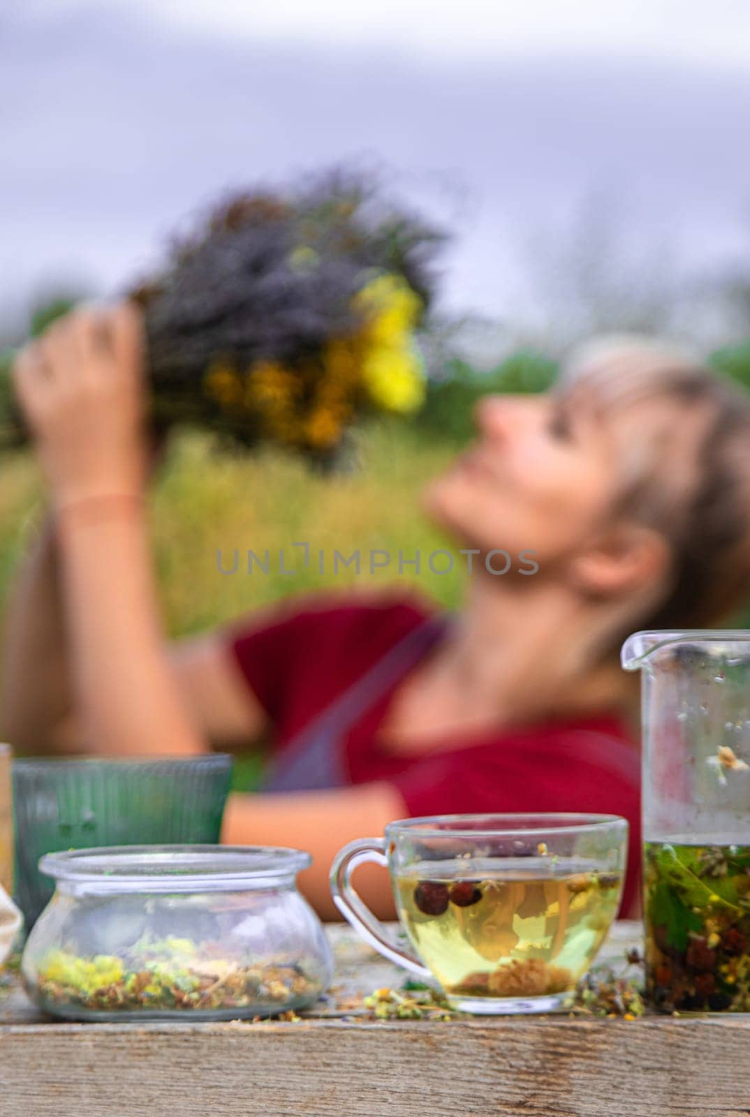 woman brews herbal tea. Selective focus. by yanadjana