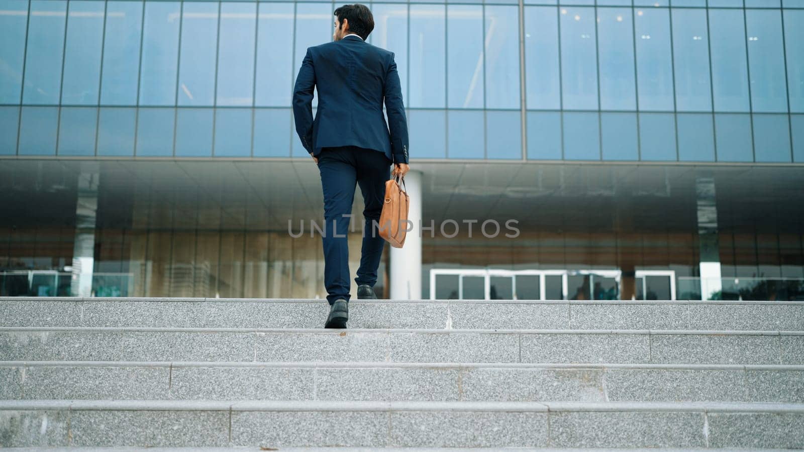 Successful business man leg walking up to stair while going to office. Project manager changing workplace, discover a new thing, growth or getting promotion or walking in to light. Rise up. Exultant.