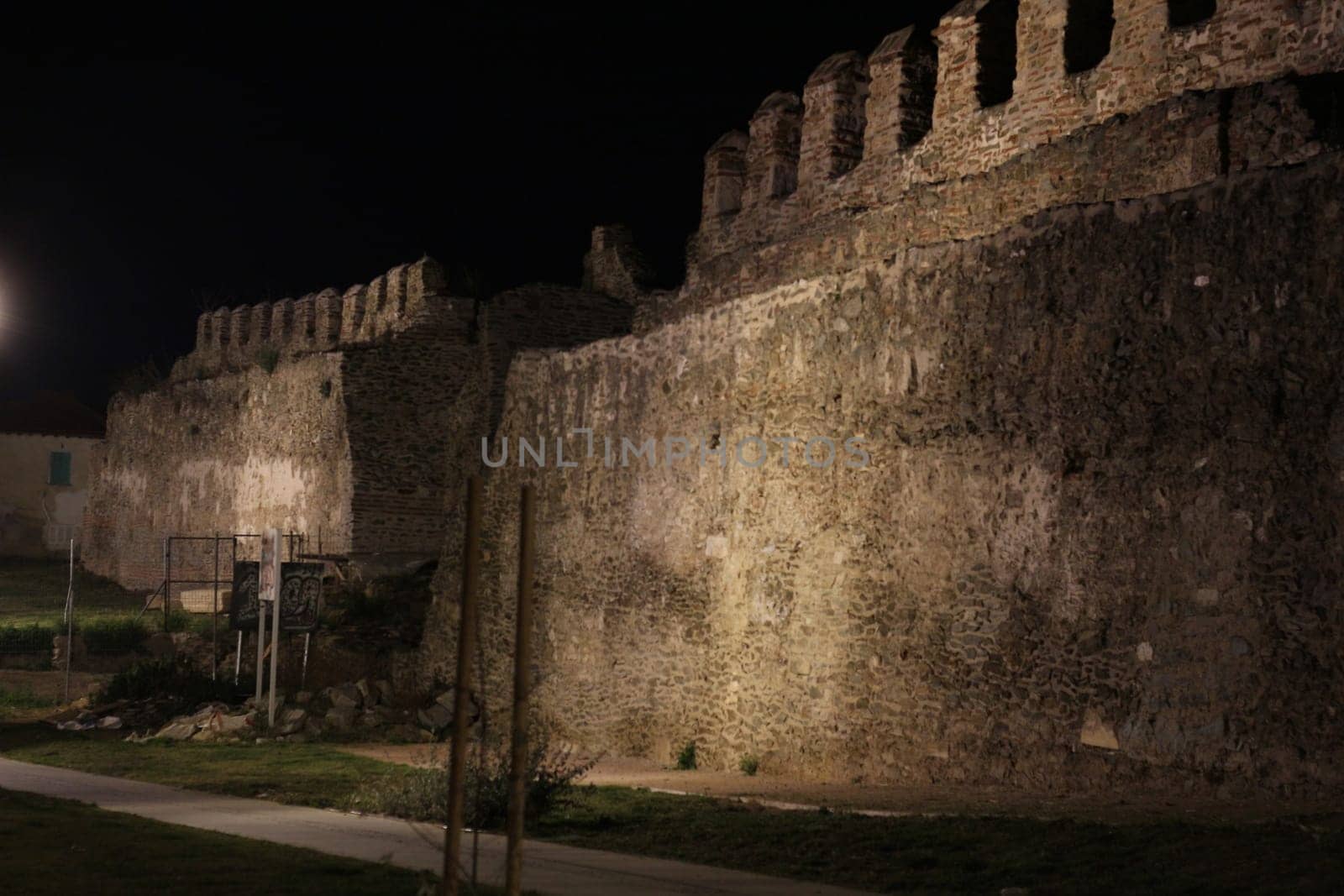 Journey through time and immerse yourself in the mystical allure of Thessaloniki's ancient city walls under the cloak of night