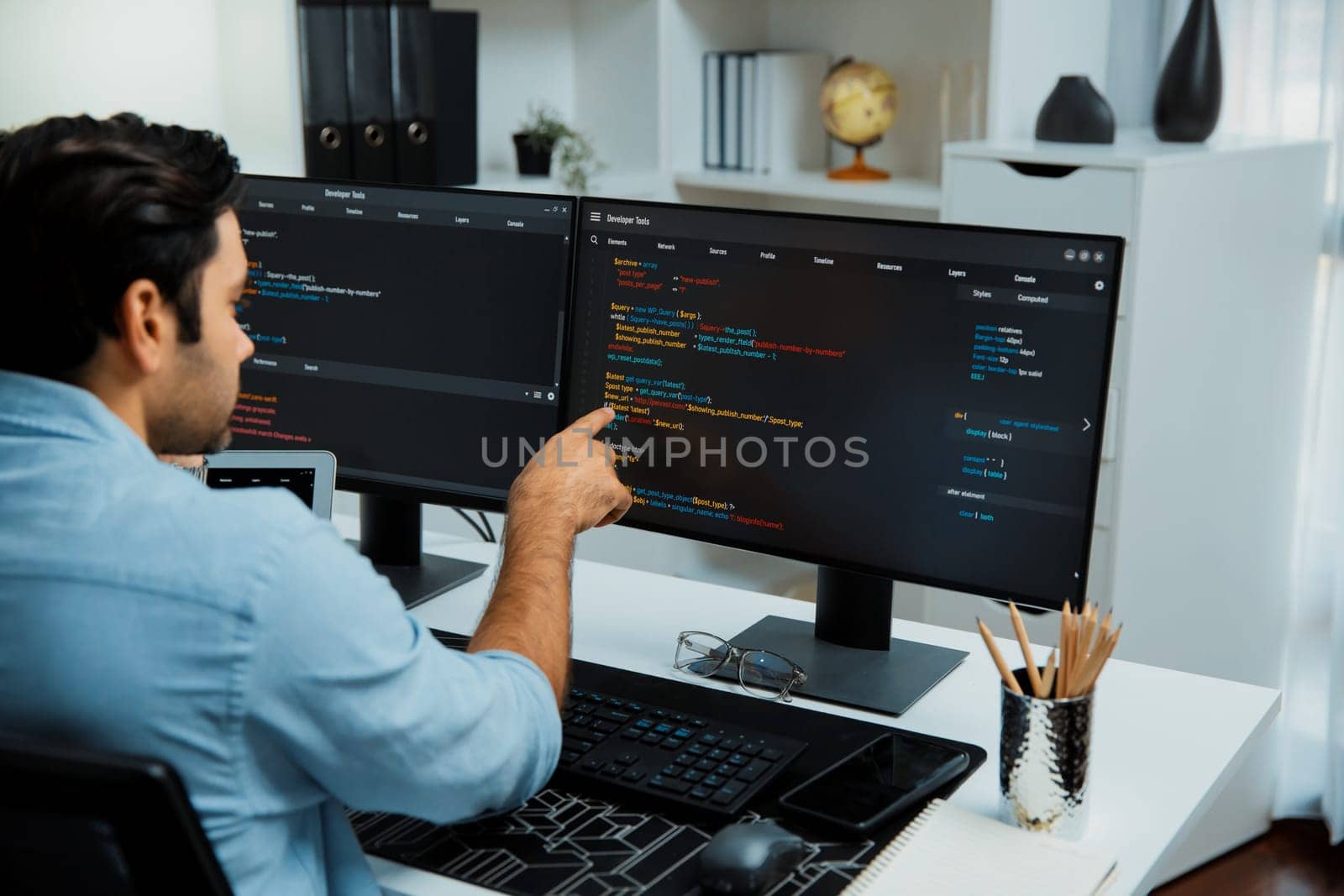 Concentrating in smart IT developer working software development coding on two pc screen, creating virus firmware application program for latest update version on website at modern office. Surmise.