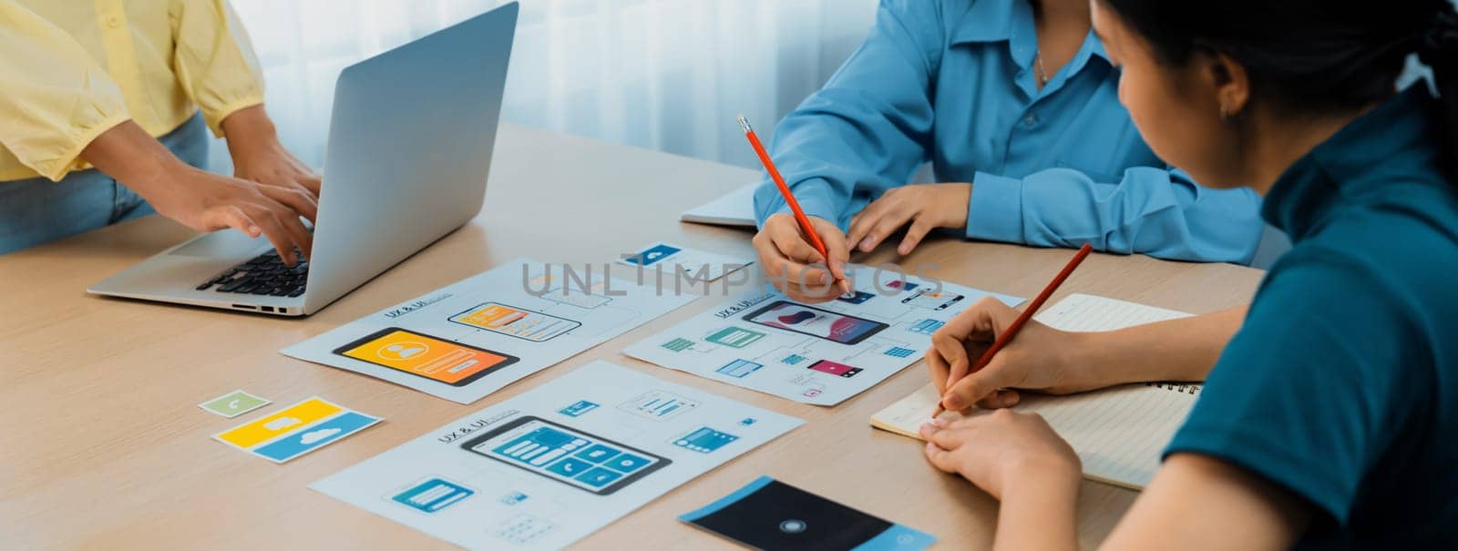 Panorama banner of startup company employee planning on user interface prototype for mobile application or website in office. UX UI designer brainstorm user friendly interface plan. Synergic