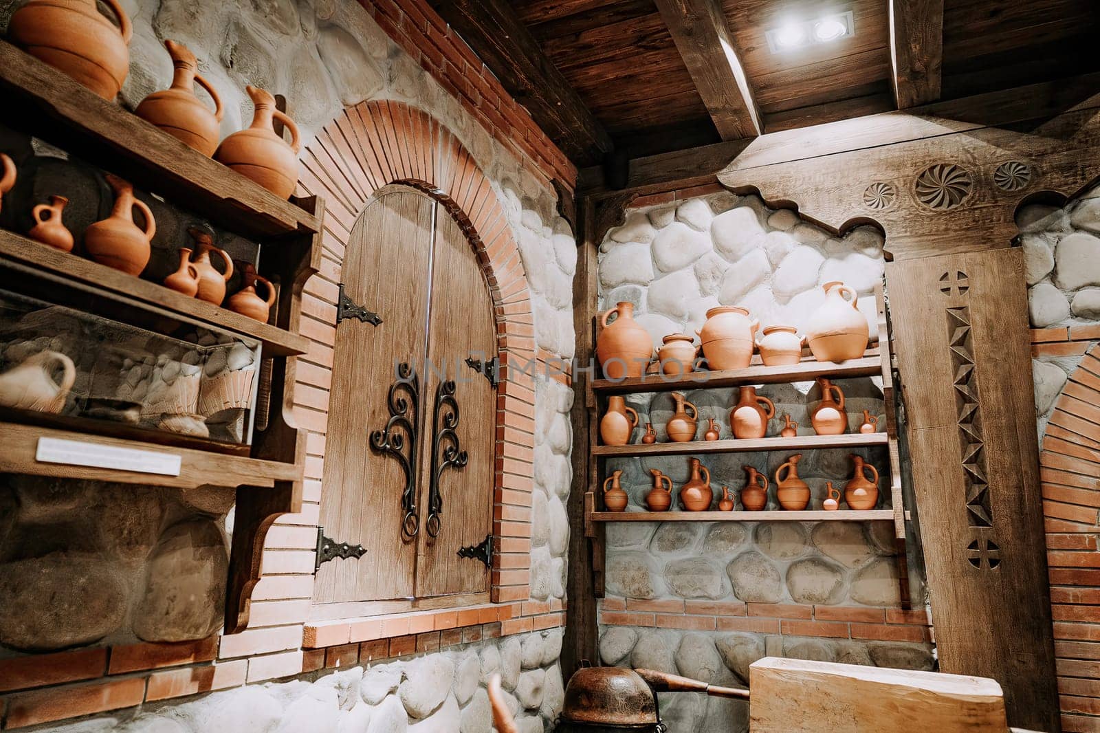 Traditional old wine cellar with handmade craft clay jugs.Antique winery concept by kristina_kokhanova