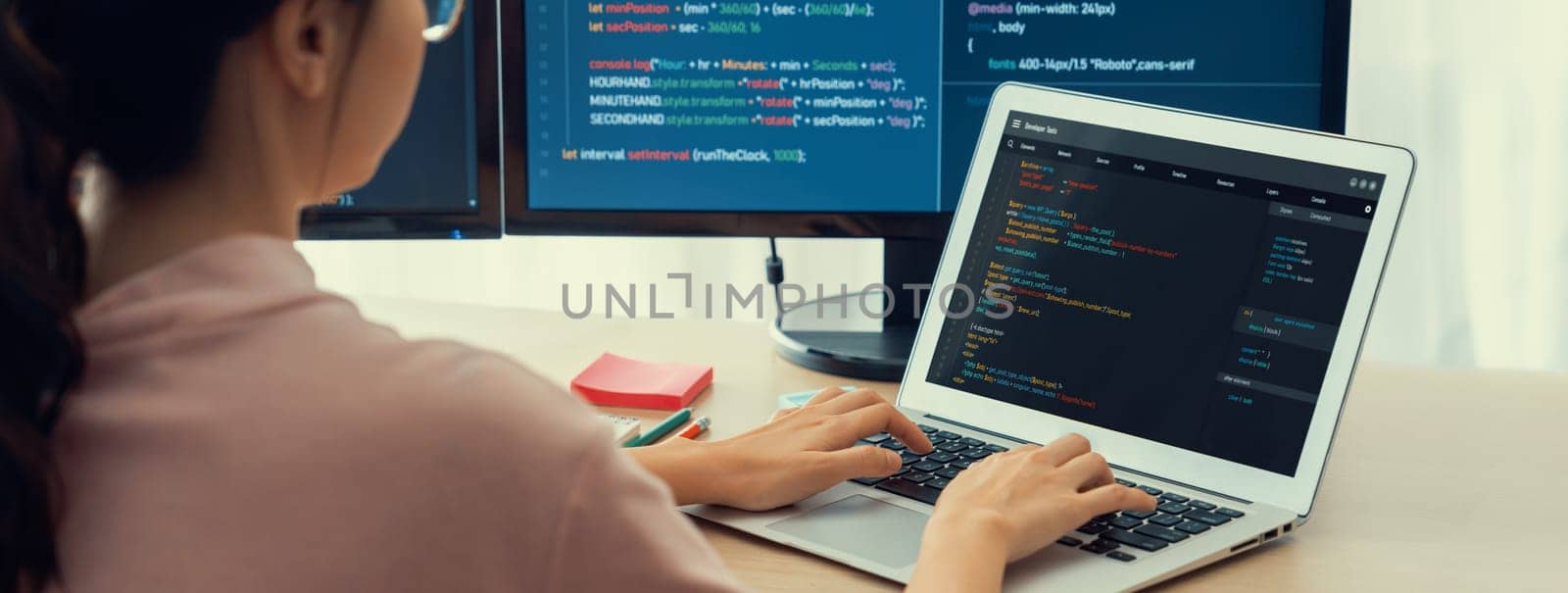 Cropped image of female web developer coding on laptop while computer displayed program and software code at modern office. Close up businesswoman hand focus on analysis data. Burgeoning.