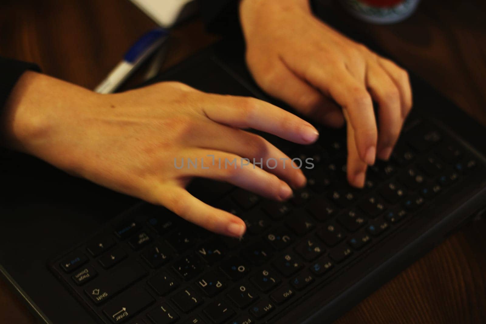 Empowered Productivity: Young Woman Engrossed in Laptop Work by DakotaBOldeman