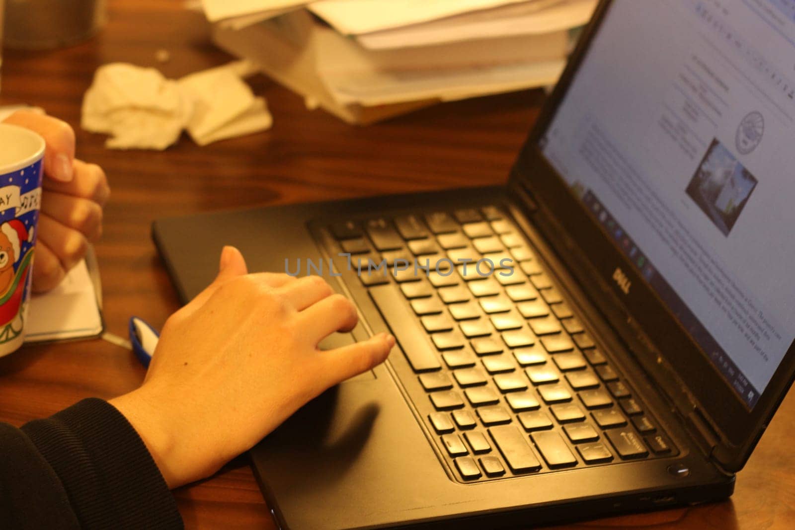 Empowered Productivity: Young Woman Engrossed in Laptop Work by DakotaBOldeman