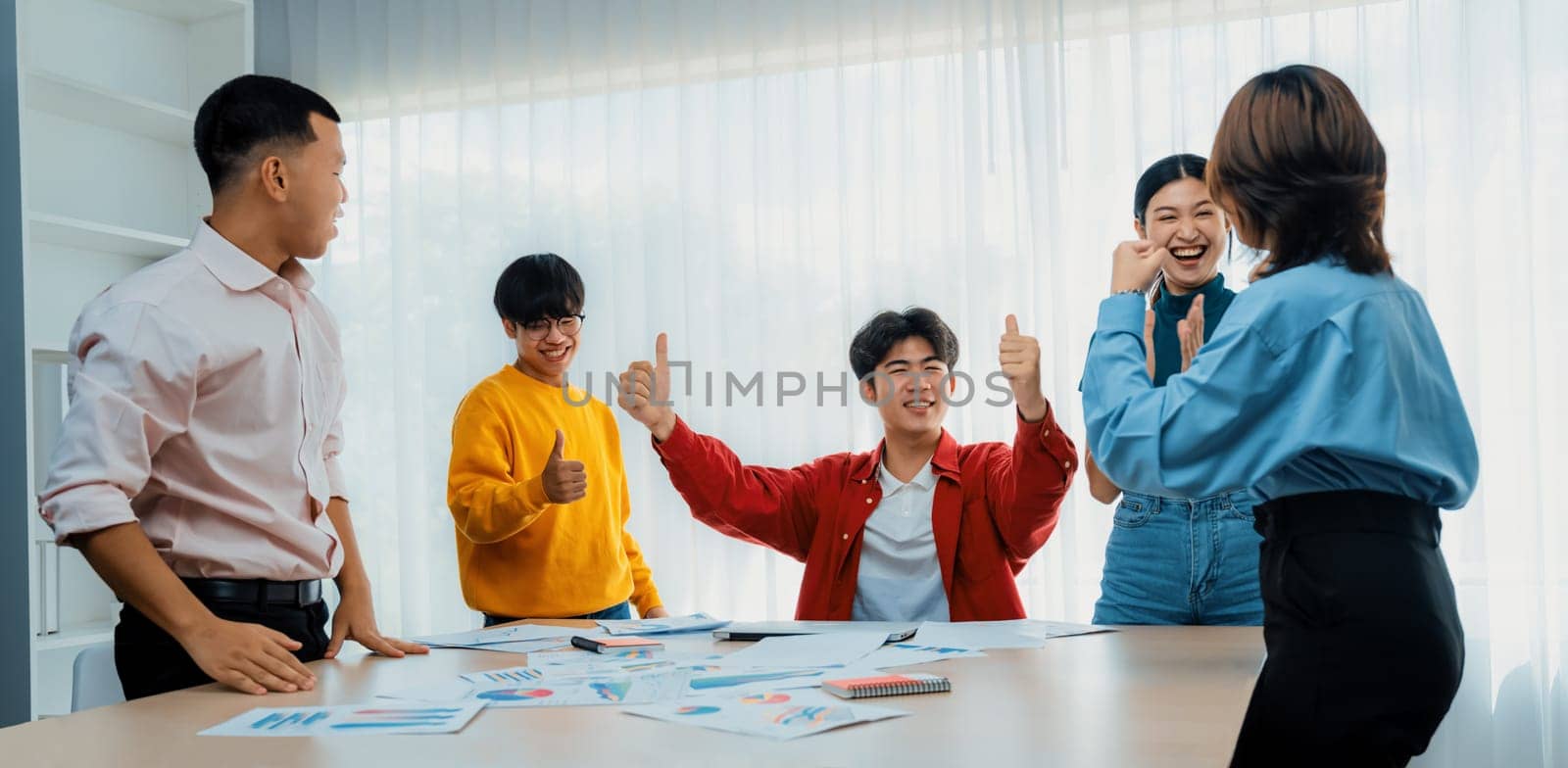 Excited and happy startup company employee celebrate after make successful strategic business marketing planning. Teamwork and positive attitude create productive and supportive workplace. Synergic