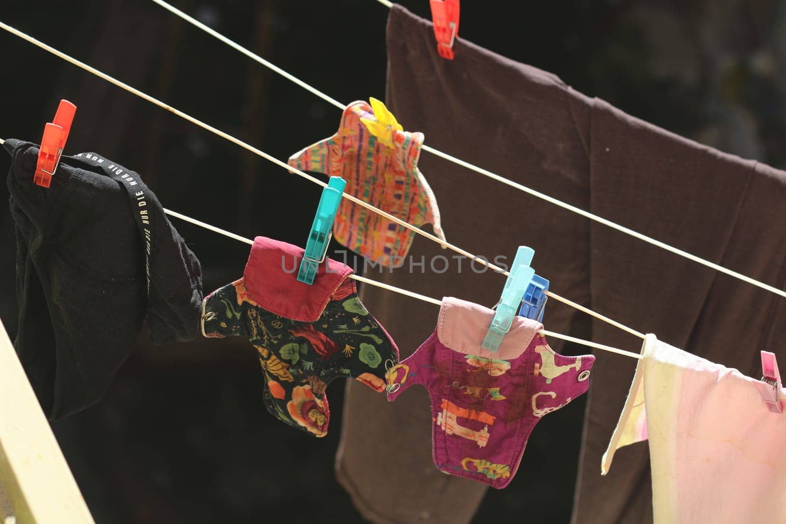 Embrace eco-friendly menstruation with these empowering images of reusable period pads hanging out to dry.