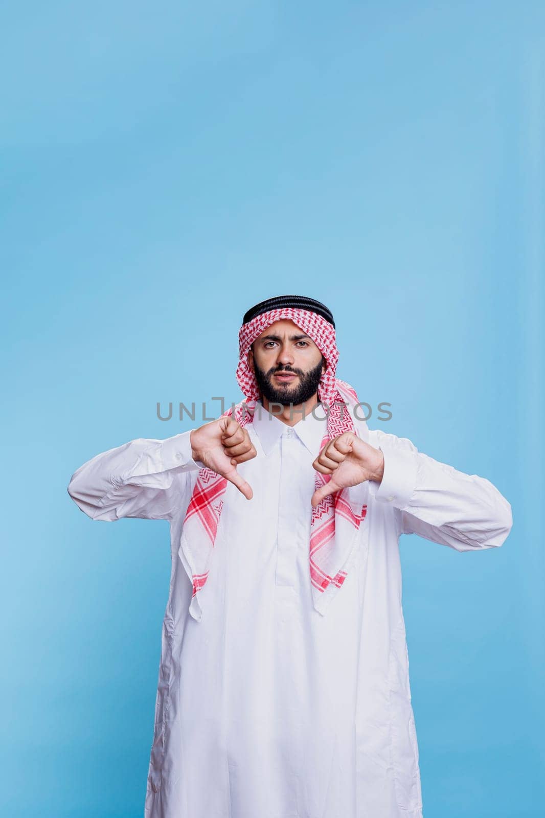 Discontent arab posing with thumbs down by DCStudio
