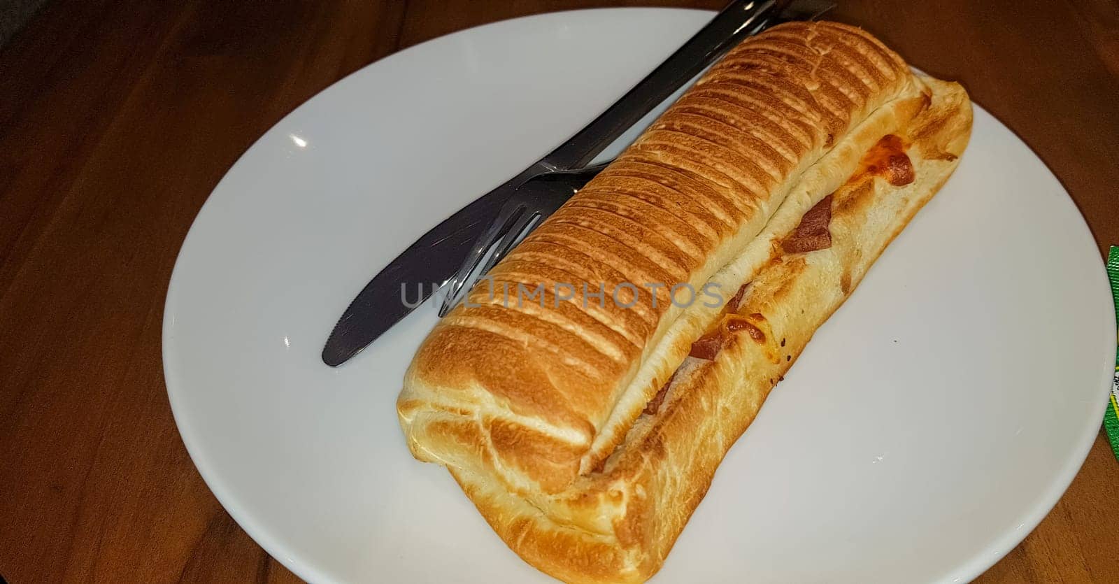 Grilled smoked beef mushroom Panini or sandwich served with white plate on the wooden table, in a famous restaurant