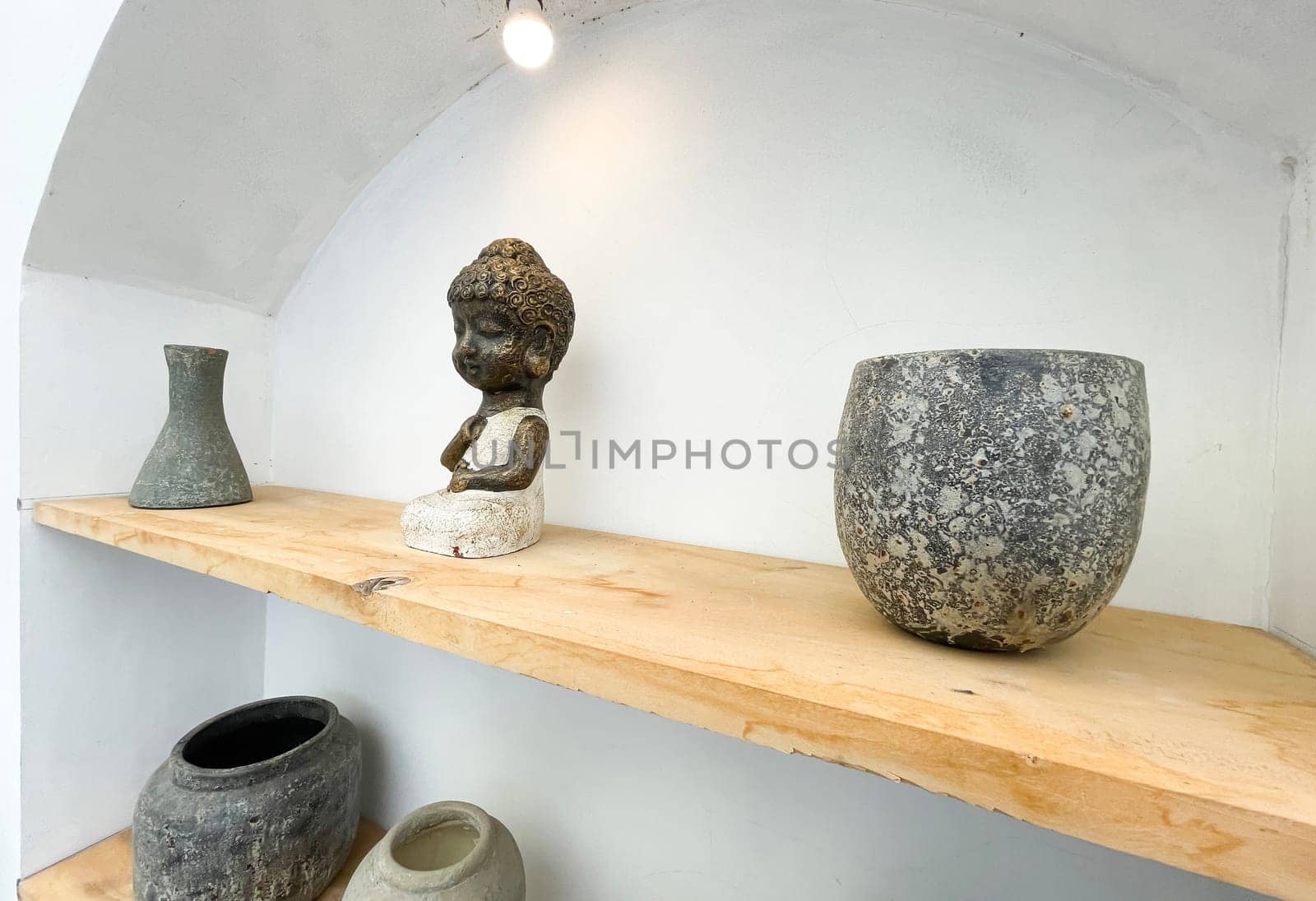 Small statue decorations for table and interior, little buddha statue modern simplistic house environment with several pottery and wooden table