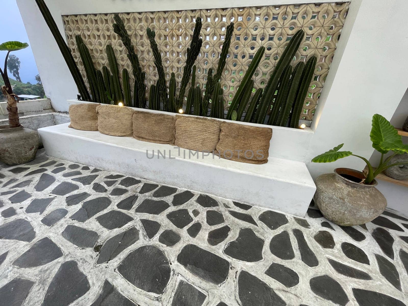 Small statue decorations for table and interior, little buddha statue modern simplistic house environment with several pottery and wooden table