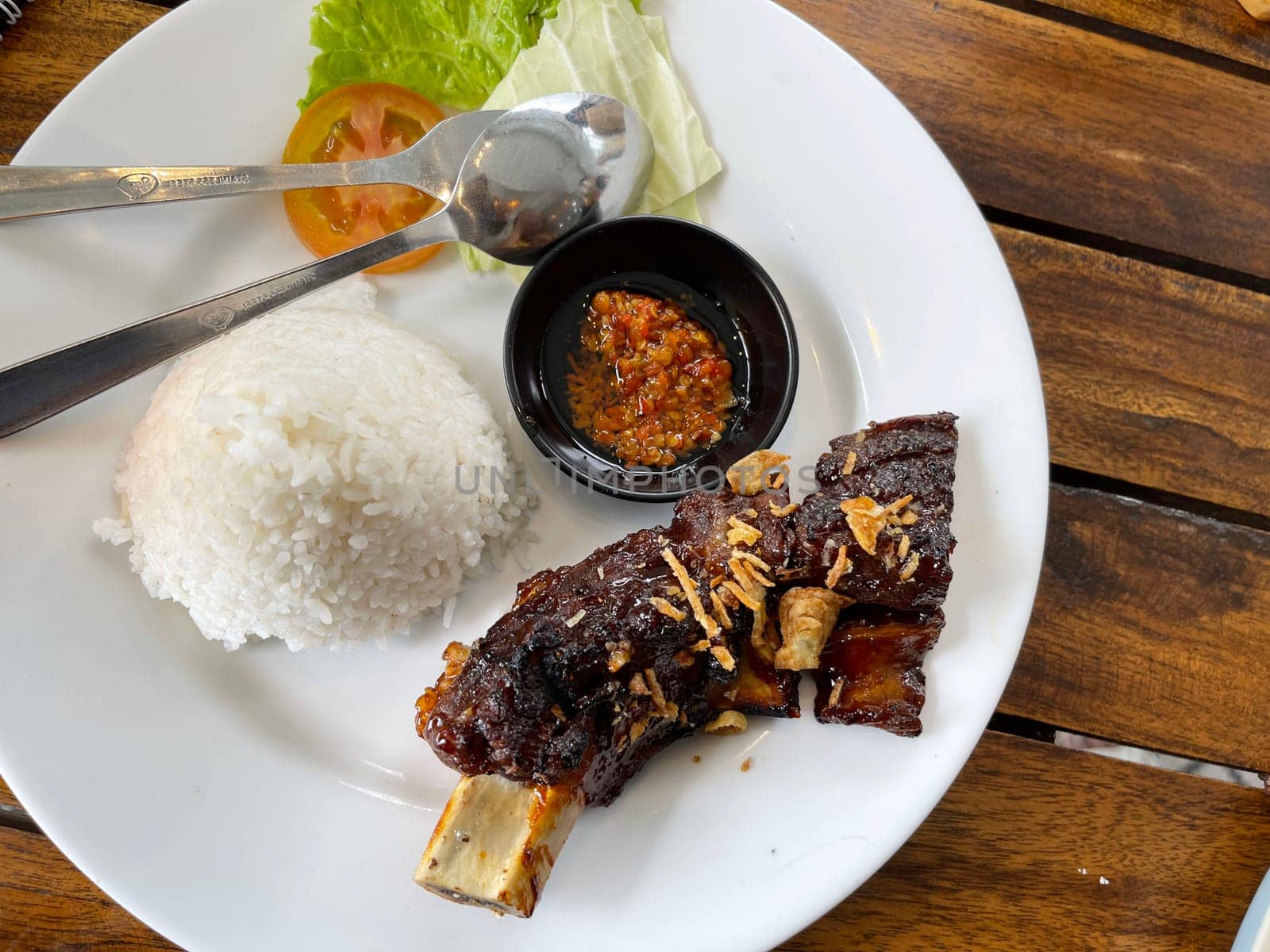 Spicy hot honey roasted grilled spare ribs from summer BBQ served with hot chili paste by antoksena
