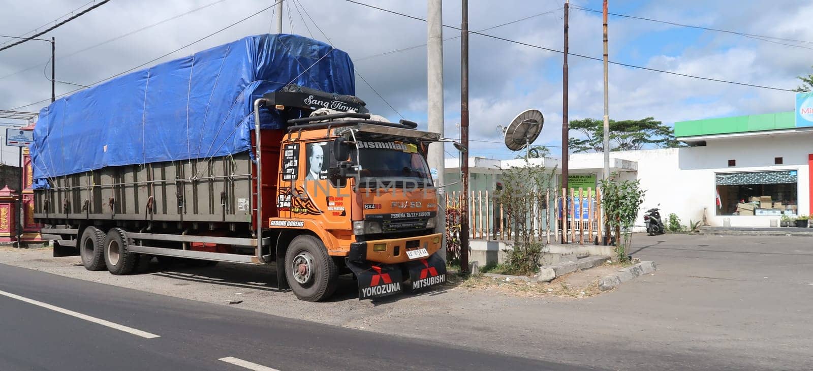 trucks making local commercial delivery at urban city and on the city streets in asia logistical transport system in Indonesia
