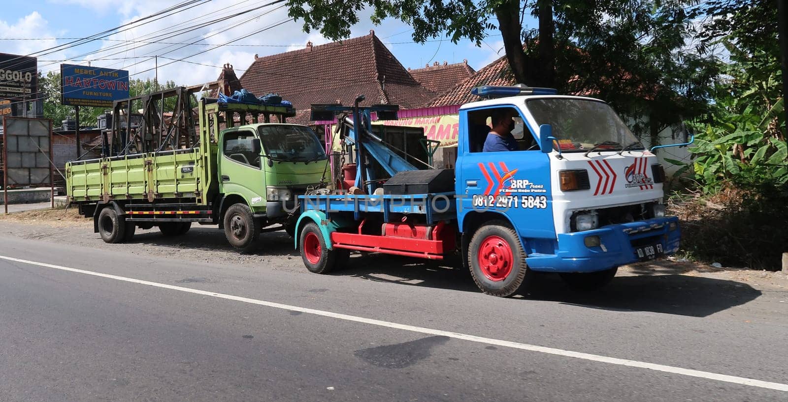 trucks making local commercial delivery at urban city and on the city streets in asia logistical transport system in Indonesia