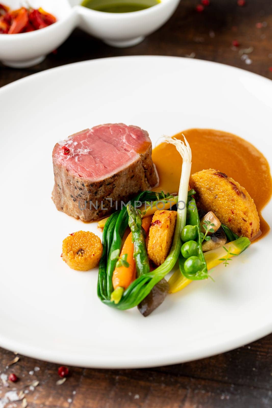 Filet mignon served with vegetables and sauces at a fine dining restaurant by Sonat