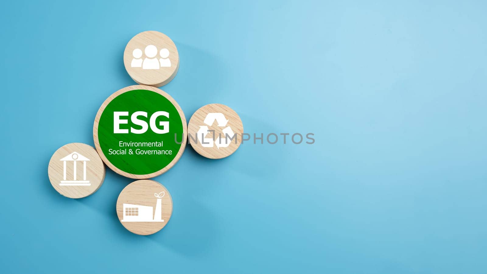 ESG concepts for sustainable environment, society and governance Businesses are environmentally responsible, A circular wooden board with the abbreviation ESG printed on a light blue background. by Unimages2527