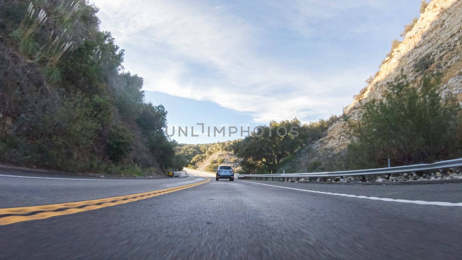 Basking in the beauty of a sunny winter day, driving on HWY 1 near Las Cruces, California offers stunning views of the picturesque coastal landscape against a backdrop of clear blue skies.