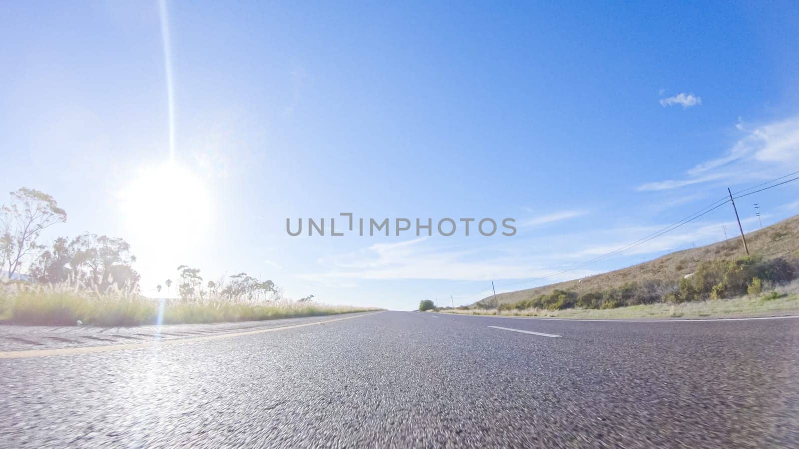 During the day, driving on HWY 101 near Arroyo Quemada Beach, California, offers scenic views of the surrounding coastal landscape.