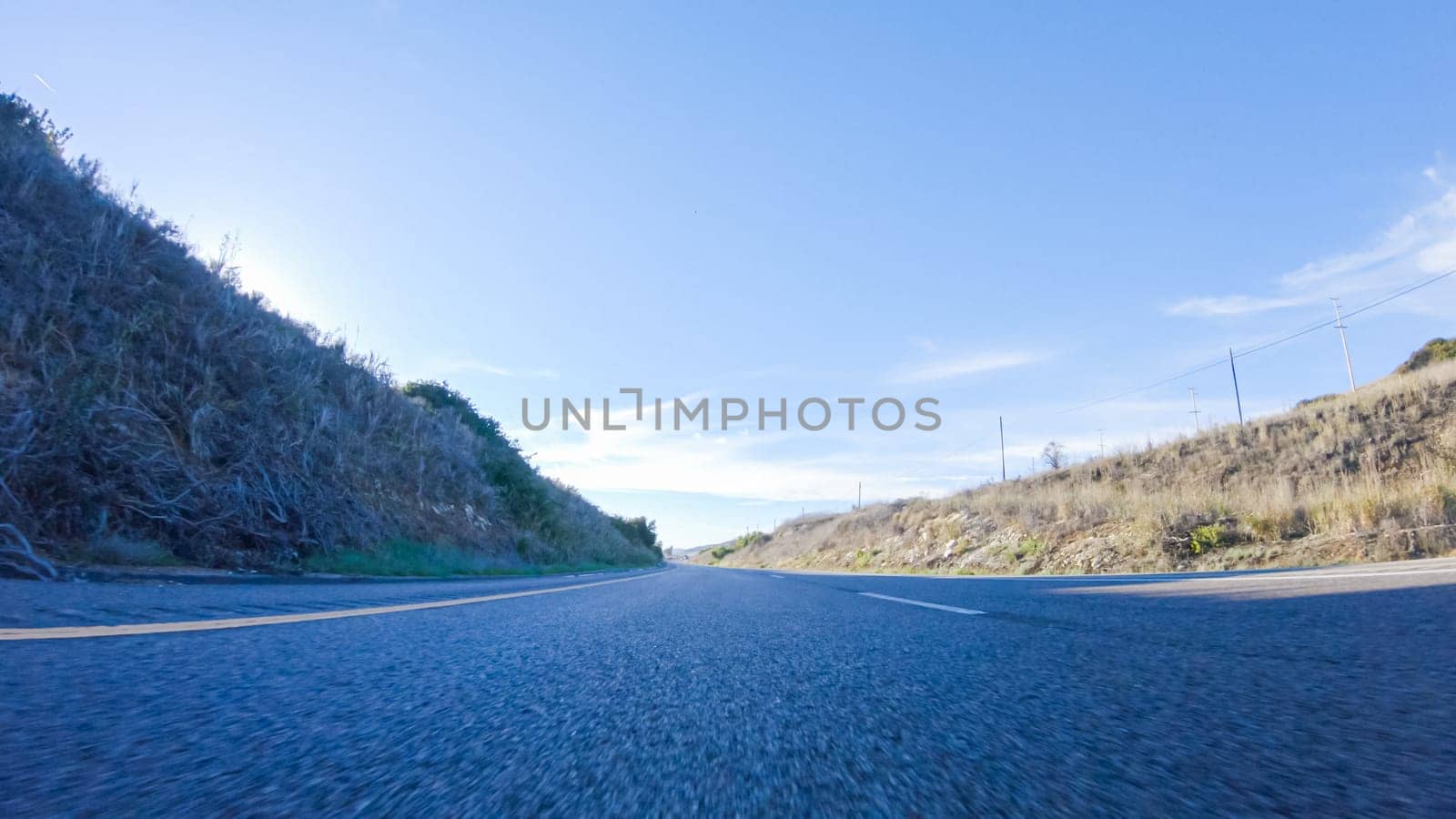 During the day, driving on HWY 101 near Arroyo Quemada Beach, California, offers scenic views of the surrounding coastal landscape.