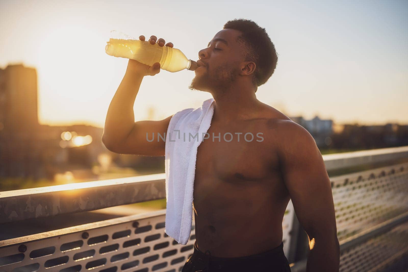 Young man Is drinking water and relaxing after jogging by djoronimo
