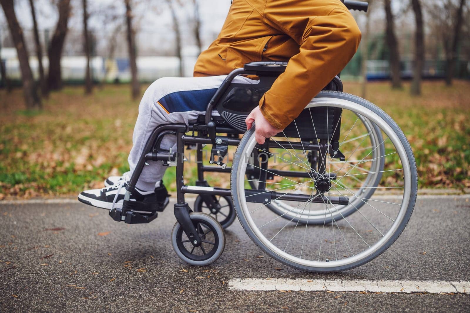 Close up image of paraplegic handicapped man in wheelchair in park by djoronimo