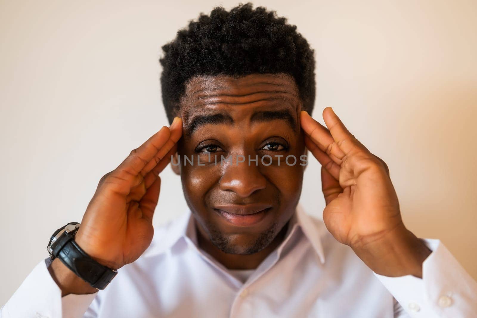 Portrait of young businessman who is tired and having headache.