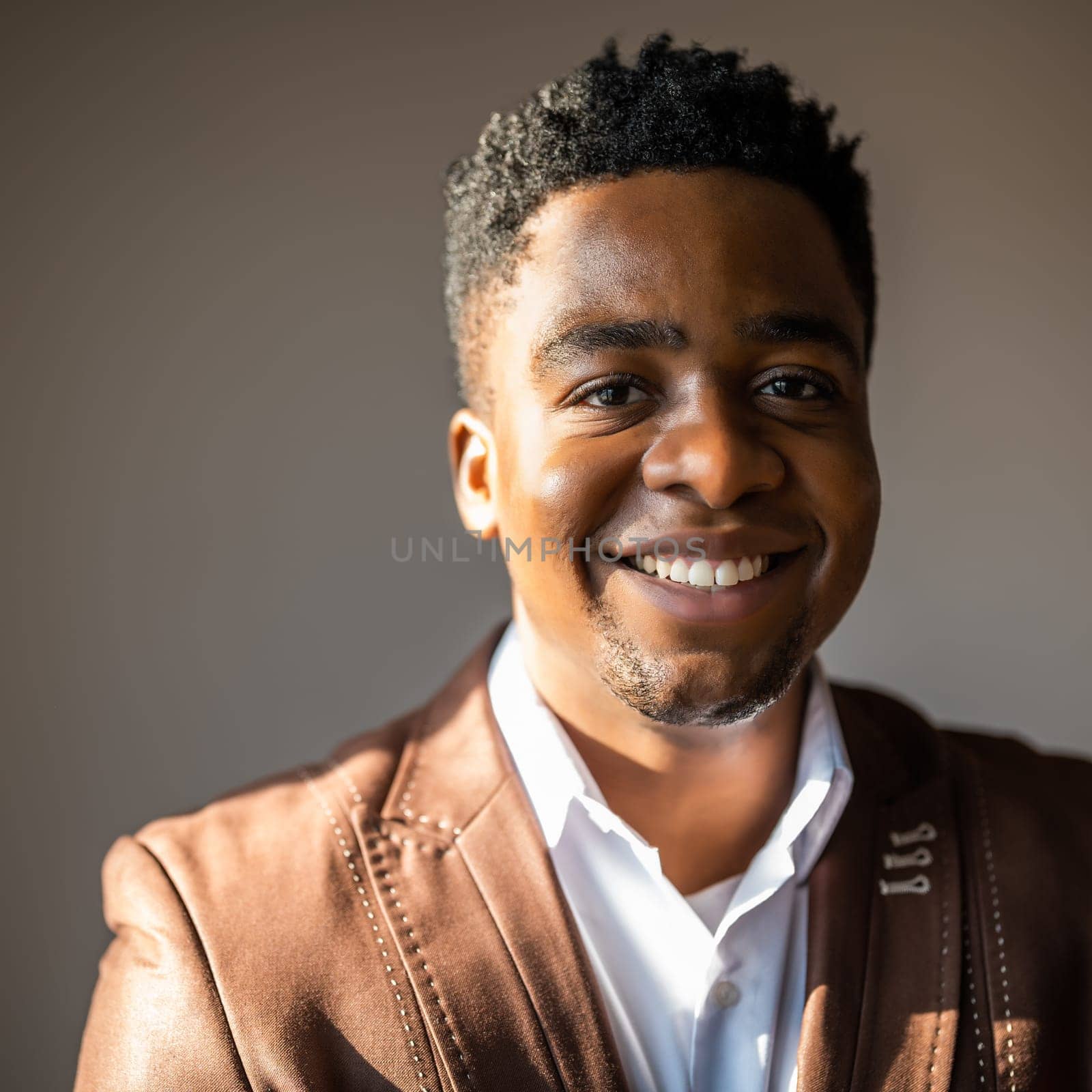 Close up portrait of happy businessman who is smiling and looking at camera.