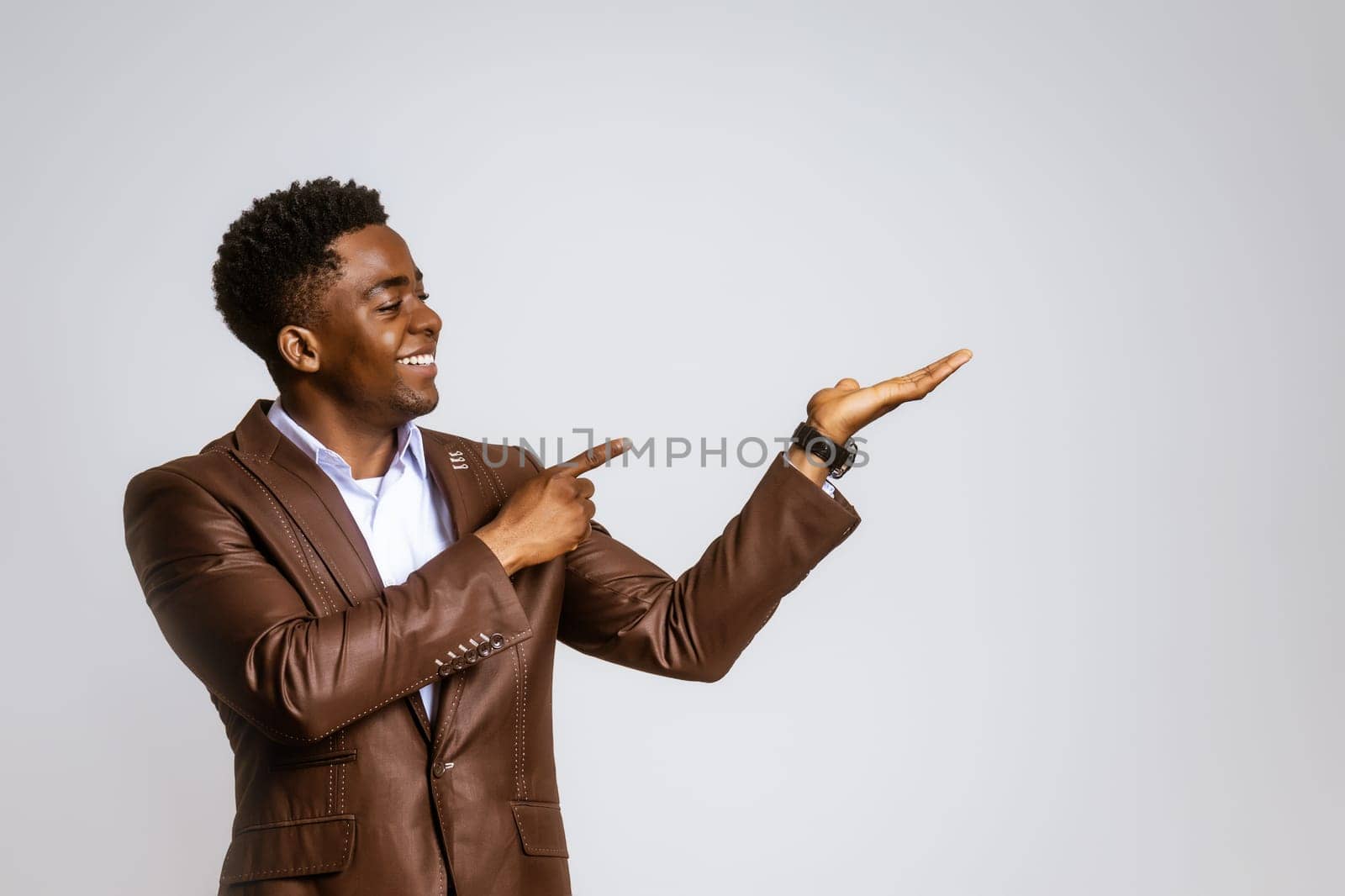 Portrait of happy businessman who is smiling and holding hand at blank space on image by djoronimo