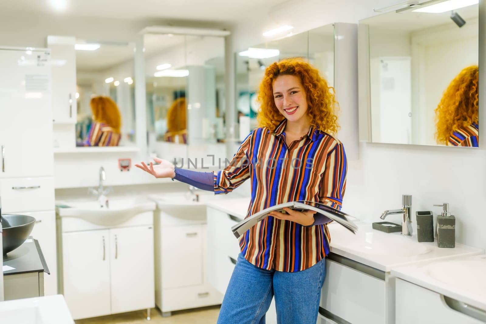 Portrait of salesperson in bathroom store. Happy redhead woman works in bath store. Sales occupation.